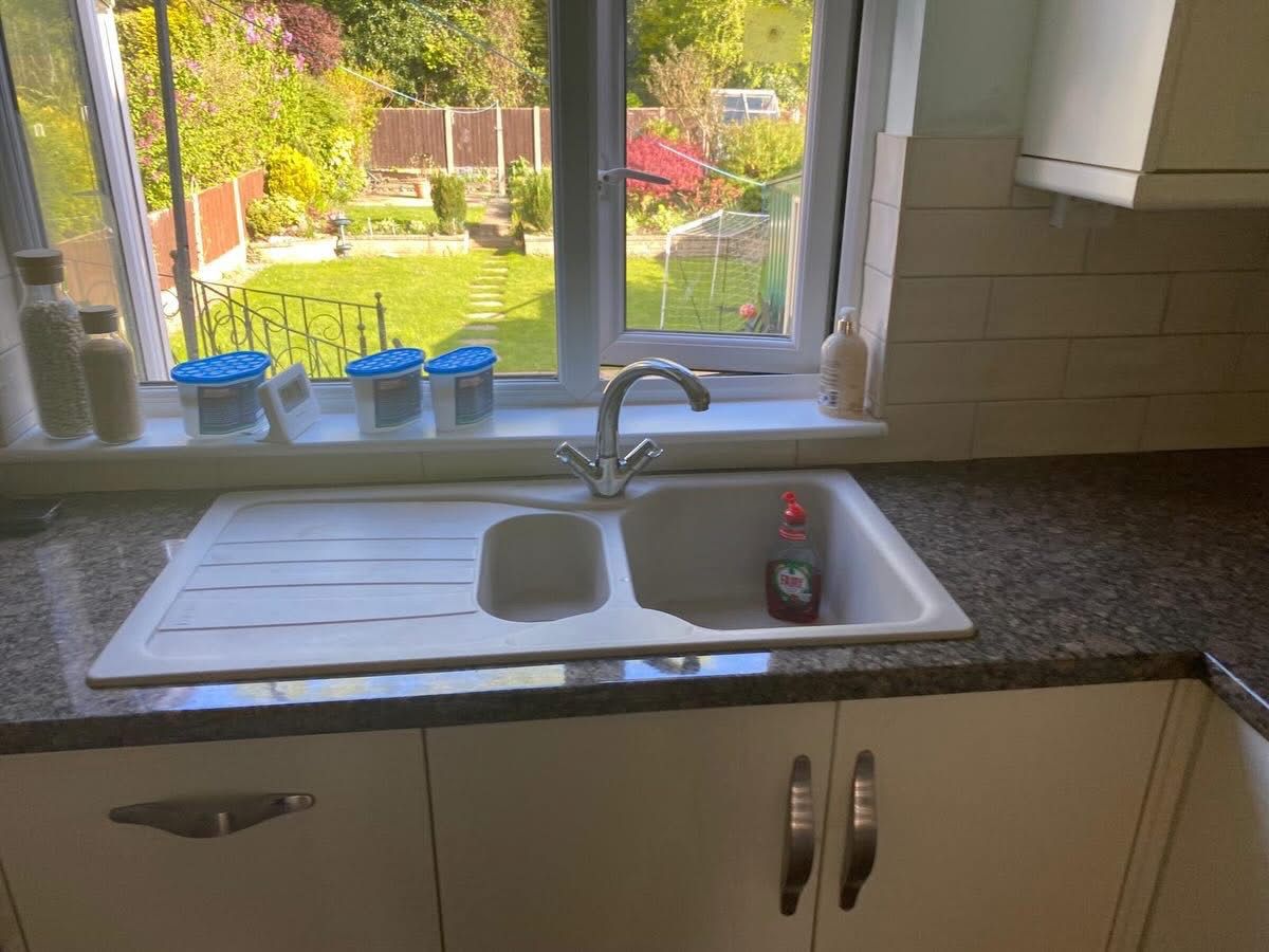 Original dark sink area before vinyl wrap