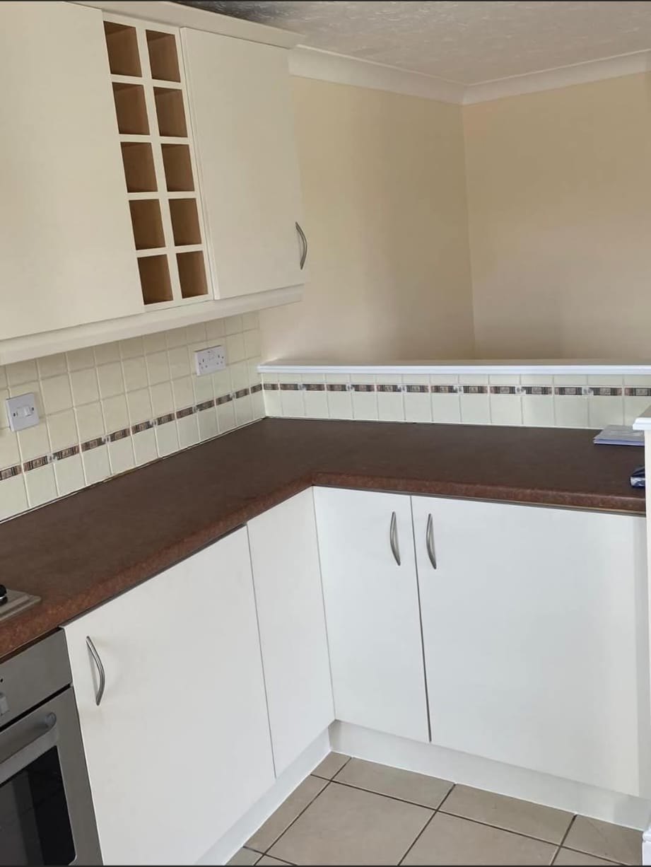 Cream wrapped kitchen cabinets and corner units after vinyl wrap