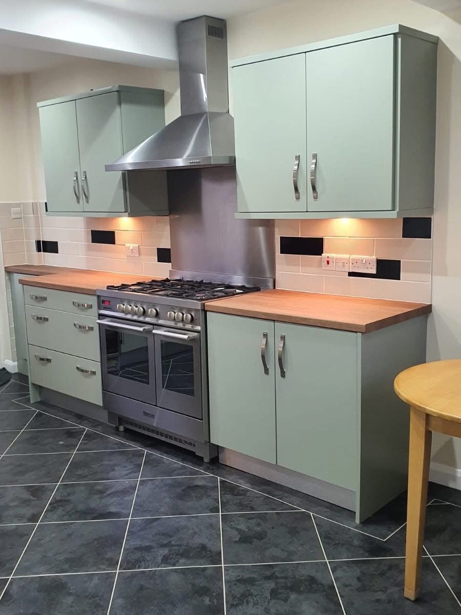 Sage green kitchen cabinets after vinyl wrap transformation
