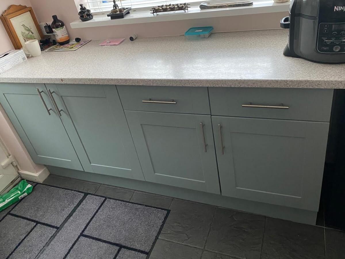 Sage green lower cabinets after vinyl wrap
