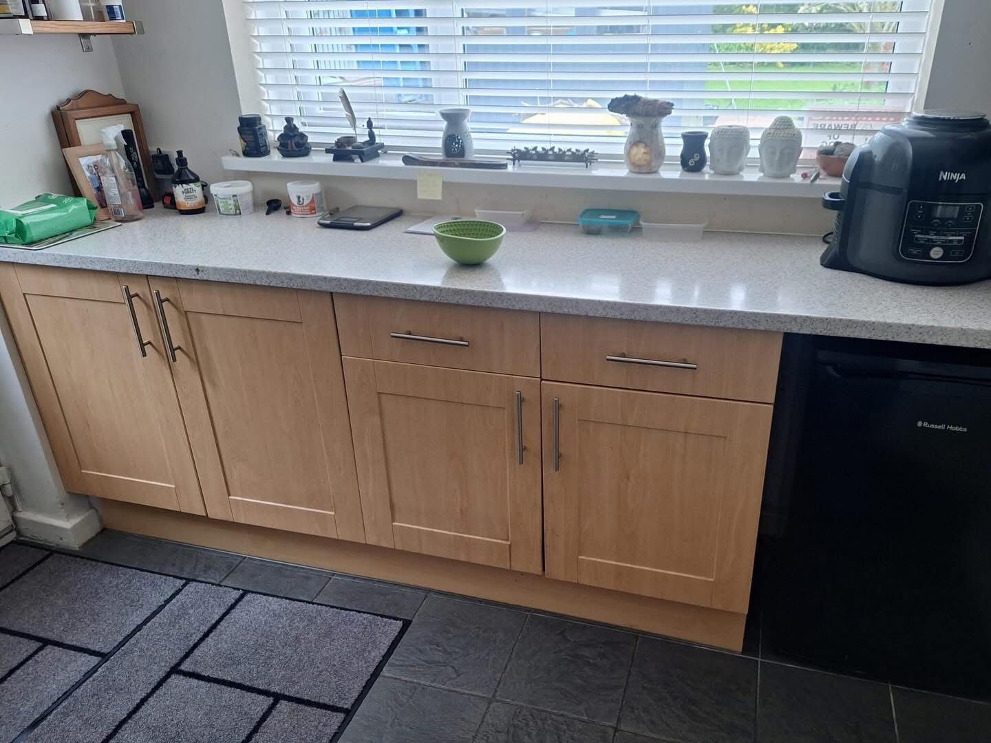 Light oak kitchen lower cabinets before vinyl wrap